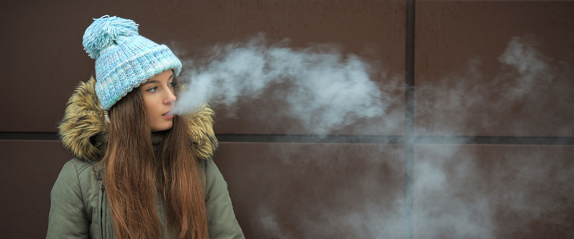 Young woman smoking outdoors