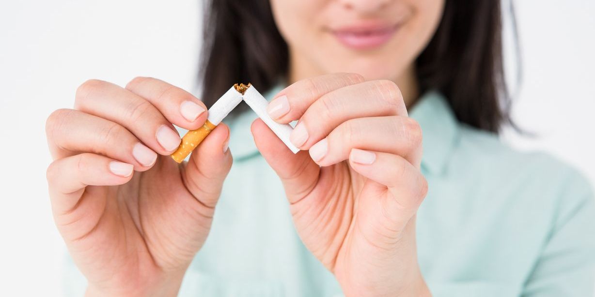 woman breaking cigarette to demonstrate smoking addiction ending