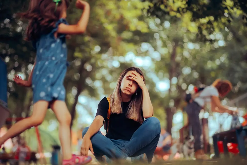 Stressed young woman sitting on floor