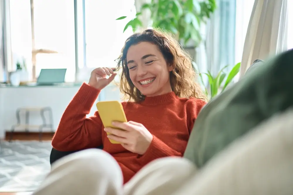 Woman smiling while on phone