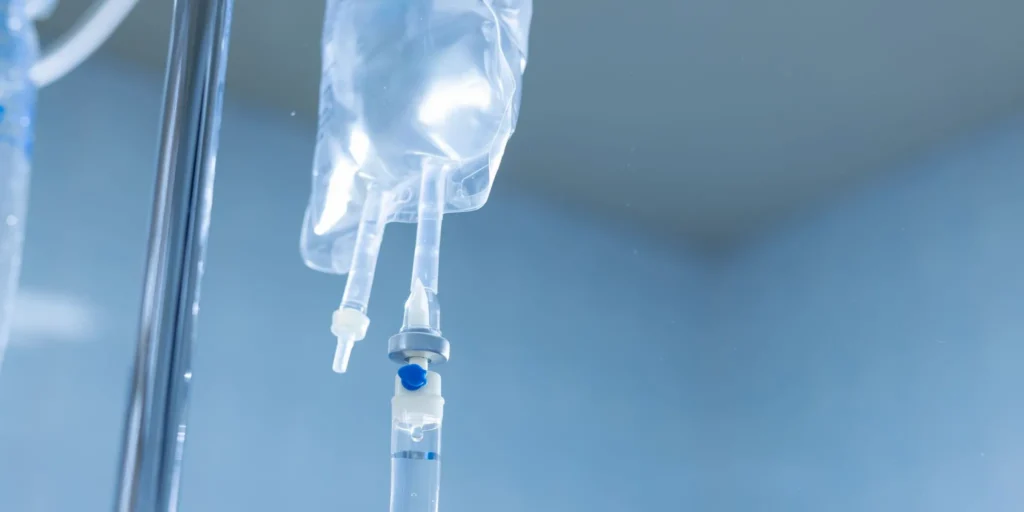 Comfortable clinical treatment room where a patient receives a supervised IV infusion for depression