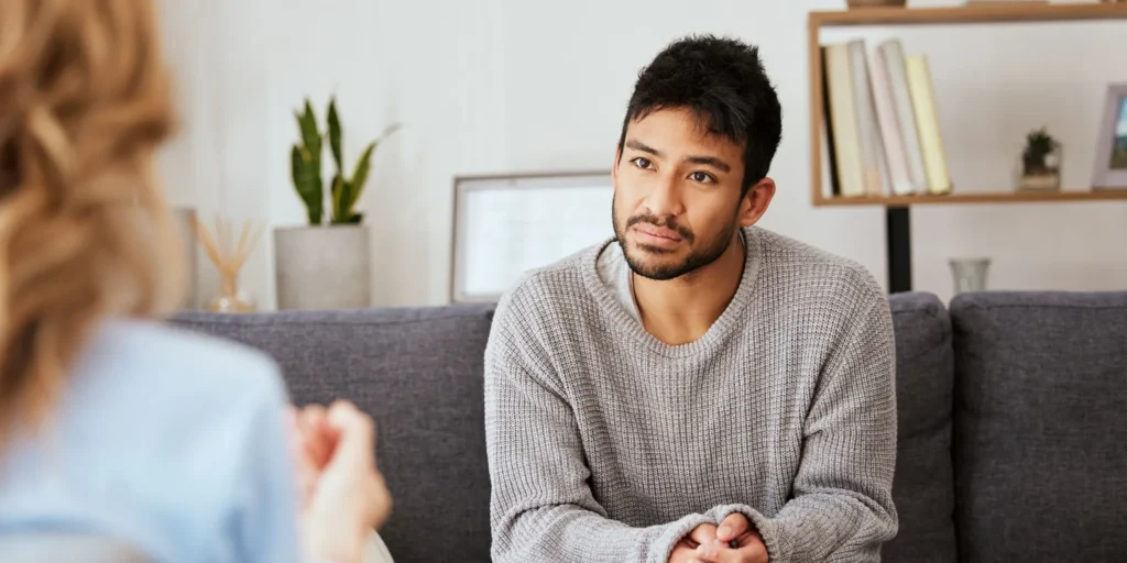Patient receiving interventional psychiatry treatment from a clinician in a modern mental health clinic.